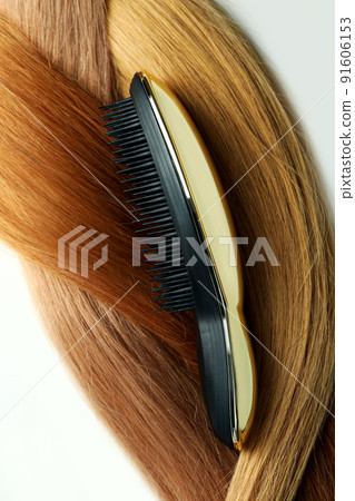 Female hair with hairbrush on white background Female hair with hairbrush on white background 91606153