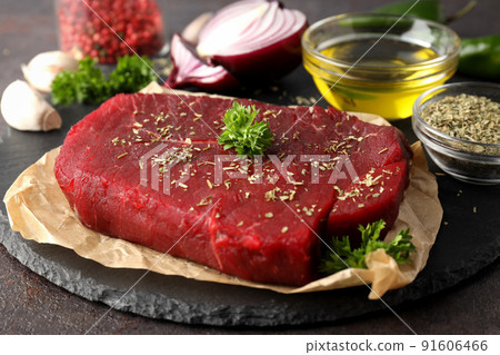 Concept of tasty food with raw beef steak, close up Concept of tasty food with raw beef steak, close up 91606466