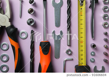 Work tools on purple background, top view Work tools on purple background, top view 91606604