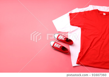 Blank t-shirts and sneakers on pink background 91607360