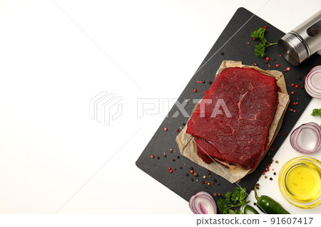 Concept of cooking with raw beef steak on white background Concept of cooking with raw beef steak on white background 91607417