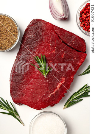 Concept of cooking with raw beef steak on white background Concept of cooking with raw beef steak on white background 91607421