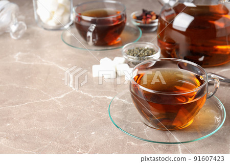 Concept of hot drink with tea on beige textured background Concept of hot drink with tea on beige textured background 91607423