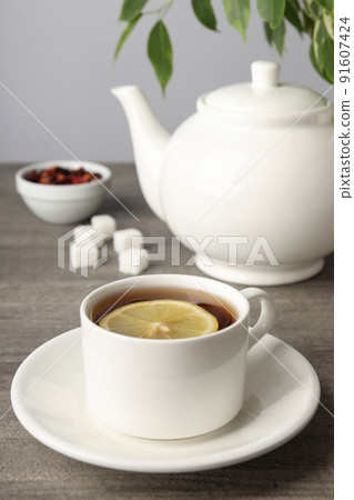 Concept of hot drink with tea on gray wooden table Concept of hot drink with tea on gray wooden table 91607424
