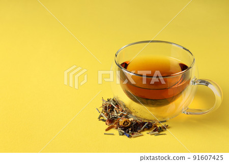 Concept of hot drink with tea on yellow background Concept of hot drink with tea on yellow background 91607425