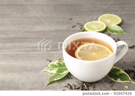 Concept of hot drink with tea on gray wooden background Concept of hot drink with tea on gray wooden background 91607426