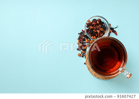 Concept of hot drink with tea on blue background Concept of hot drink with tea on blue background 91607427