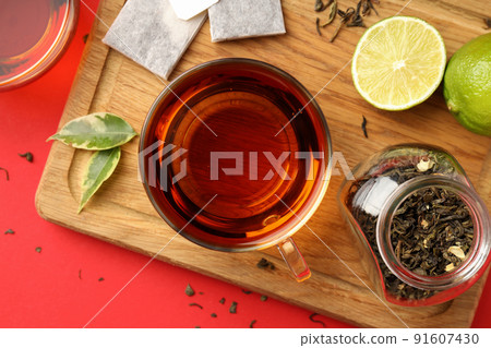 Concept of hot drink with tea on red background Concept of hot drink with tea on red background 91607430