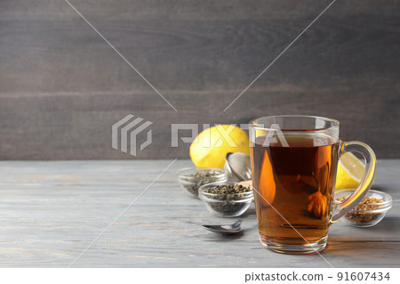 Concept of hot drink with tea on gray wooden table Concept of hot drink with tea on gray wooden table 91607434