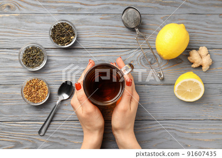 Concept of hot drink with tea on gray wooden background Concept of hot drink with tea on gray wooden background 91607435