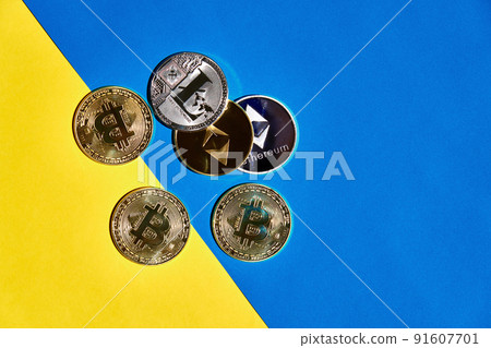 Heap of digital currency golden and silver on yellow and blue background 91607701