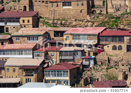 facades of houses located in tiers on a steep slope in the village of Chokh in Dagestan 91607714