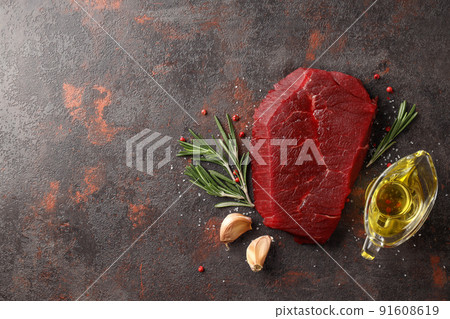 Concept of cooking with raw steak on textured background 91608619