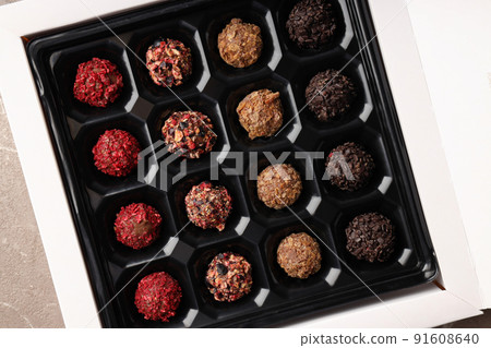 Concept of sweets with chocolate candies on textured background Concept of sweets with chocolate candies on textured background 91608640