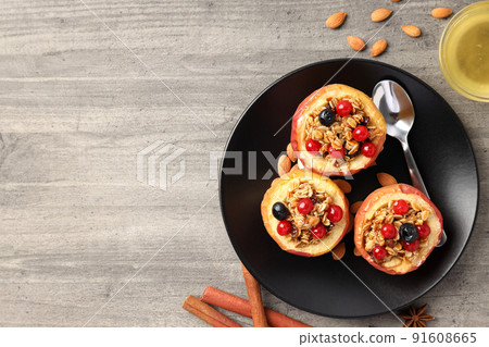 Concept of tasty food with baked apples on gray wooden background Concept of tasty food with baked apples on gray wooden background 91608665