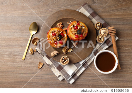 Concept of tasty food with baked apples on wooden background Concept of tasty food with baked apples on wooden background 91608666