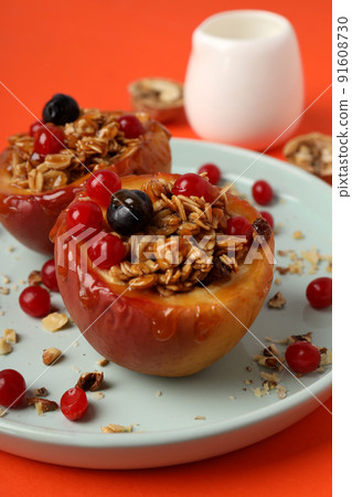 Concept of tasty food with baked apples on orange background 91608730