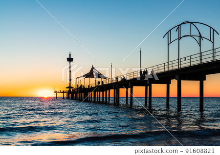 Brighton jetty with people walking along at sunset 91608821
