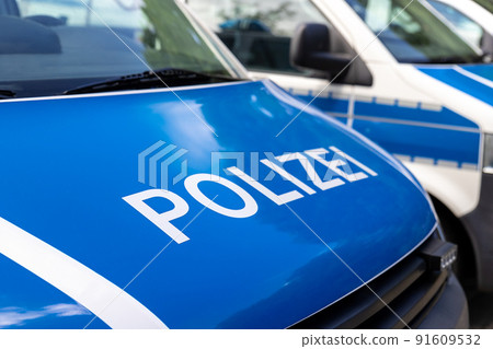 Close-up detail view of many german police van cars parked in raw on police station parking on sunny day. Civil emergency law security and traffic service vehicle in Europe Close-up detail view of many german police van cars parked in raw on police station parking on sunny day. Civil emergency law security and traffic service vehicle in Europe 91609532