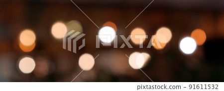 Defocused bokeh lights on black background, an abstract naturally blurred backdrop for Christmas eve or birthday party. Festive light texture. Colorful garland in blur. Overlay effect for design 91611532