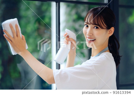 Housework image of a young housewife cleaning windows 91613394