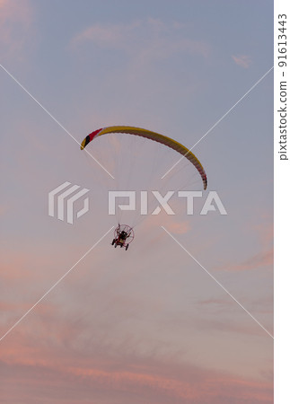 Aerial view on aeroplane in rose orange sunset sky Aerial view on aeroplane in rose orange sunset sky 91613443