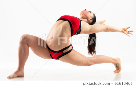 Sporty beautiful young woman practicing yoga, doing lunge exercise, Revolved Side Angle Pose, , working out wearing red and black sportswear, studio full length, isolated white background. Sporty beautiful young woman practicing yoga, doing lunge exercise, Revolved Side Angle Pose, , working out wearing red and black sportswear, studio full length, isolated white background. 91613465