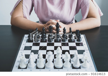The chess board shows leadership, Hand of businesswoman moving, chess in competition shows leadership, followers, and business success strategies 91614613