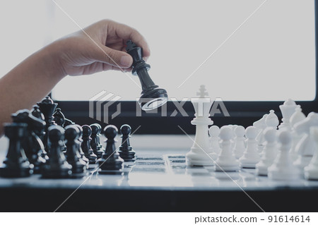 Hand of businesswoman moving, chess in competition shows leadership, followers, and business success strategies 91614614