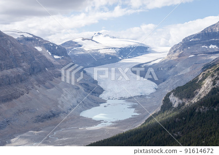 Massive melting glacier with glacial pool on its bottom, horizontal shot, Jasper, Canada 91614672