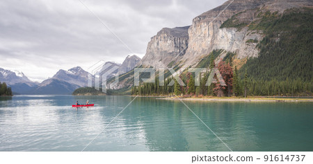 Kayaking on a turquoise alpine lake surrounded by mountains, Jasper National Park, Canada 91614737