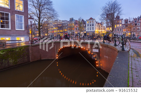 Beautiful old houses on the city waterfront of Amsterdam at sunset. Beautiful old houses on the city waterfront of Amsterdam at sunset. 91615532