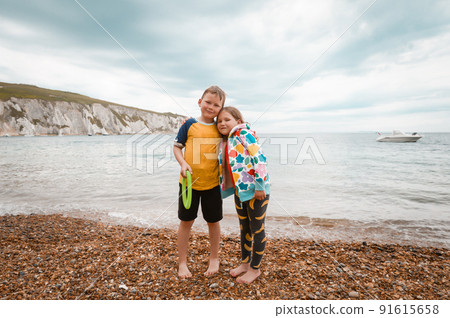 Kids boy and girl on Freshwater Bay, Isle of Wight, UK Holiday Happy children on sea beach at Freshwater bay popular holiday resort on the Isle of Wight. 91615658
