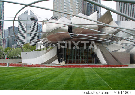CHICAGO, ILLINOIS, UNITED STATES - MAY 12, 2018: Jay Pritzker Pavilion is the concert shell designed by architect Frank Gehry in Millennium Park on a sunny spring day 91615805