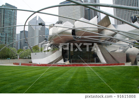 CHICAGO, ILLINOIS, UNITED STATES - MAY 12, 2018: Jay Pritzker Pavilion is the concert shell designed by architect Frank Gehry in Millennium Park on a sunny spring day 91615808