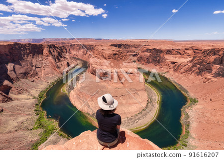 Adventurous Caucasian Woman at Horseshoe Bend in Page, Arizona, United States. Adventurous Caucasian Woman at Horseshoe Bend in Page, Arizona, United States. 91616207