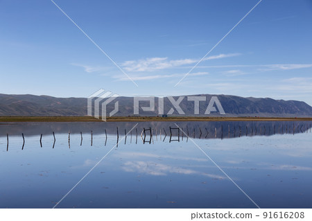 Flooded Farmland and Fence surrounded by Mountains. Flooded Farmland and Fence surrounded by Mountains. 91616208