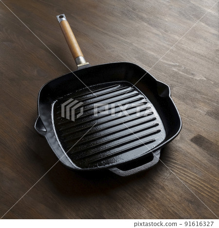 Empty grill pan for frying bbq on wooden table Empty grill pan for frying bbq on wooden table 91616327