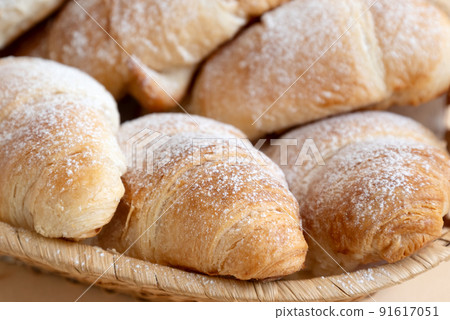 Close up butter croissants sprinkled with powdered sugar, Homemade pastry Close up butter croissants sprinkled with powdered sugar, Homemade pastry 91617051