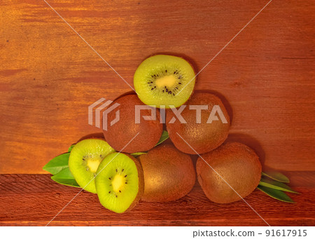 Kiwi on brown wooden background 91617915