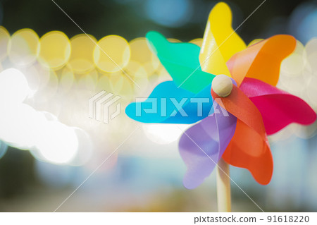 Colorful rainbow pinwheel toy with golden bokeh abstract funny background. Colorful rainbow pinwheel toy with golden bokeh abstract funny background. 91618220