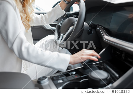 Young woman driving a car. Business lady driver of luxury car. Young woman driving a car. Business lady driver of luxury car. 91618323