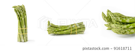 Bunch of fresh green asparagus isolated on white background. Big set freshly picked asparagus with water drops isolated on white background. Bunch of fresh green asparagus isolated on white background. Big set freshly picked asparagus with water drops isolated on white background. 91618711