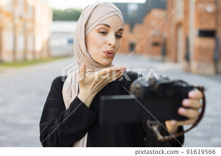 Muslim woman use camera selfie and taking picture in city. Muslim woman use camera selfie and taking picture in city. 91619566