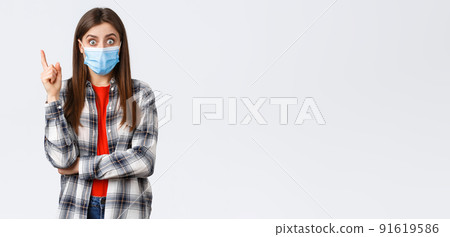 Coronavirus outbreak, leisure on quarantine, social distancing and emotions concept. Excited smart young woman in medical mask and checked shirt, raising index finger to say suggestion, have idea Coronavirus outbreak, leisure on quarantine, social distancing and emotions concept. Excited smart young woman in medical mask and checked shirt, raising index finger to say suggestion, have idea 91619586