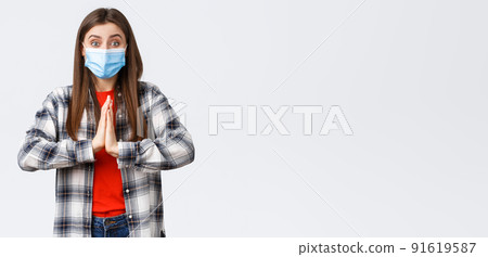 Different emotions, covid-19 pandemic, coronavirus self-quarantine and social distancing concept. Hopeful enthusisatic girl, volunteer in medical mask, asking please, begging help, hold hands in pray Different emotions, covid-19 pandemic, coronavirus self-quarantine and social distancing concept. Hopeful enthusisatic girl, volunteer in medical mask, asking please, begging help, hold hands in pray 91619587