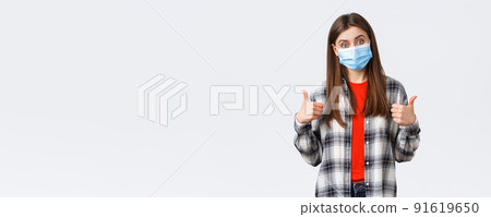 Coronavirus outbreak, leisure on quarantine, social distancing and emotions concept. Very good congratulations. Supportive cute woman in medical mask show thumb-up, like and approve Coronavirus outbreak, leisure on quarantine, social distancing and emotions concept. Very good congratulations. Supportive cute woman in medical mask show thumb-up, like and approve 91619650