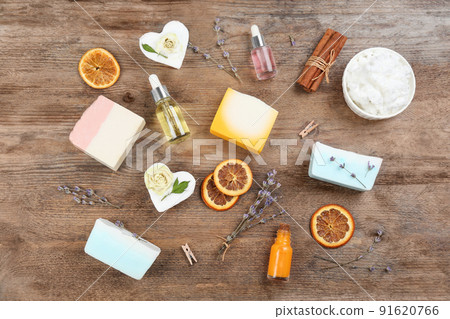 Flat lay composition with natural handmade soap and ingredients on wooden table 91620766