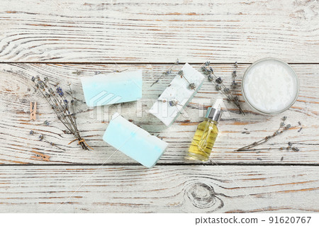 Flat lay composition with natural handmade soap and ingredients on white wooden table 91620767