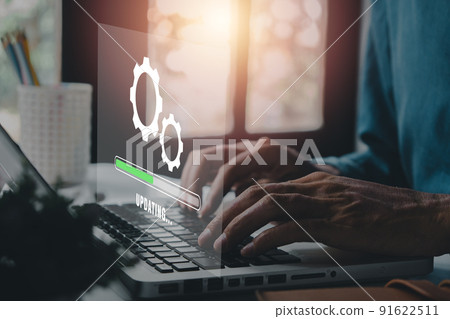 Update progress concept, Person waiting for installing update process with loading bar icon on virtual screen on laptop computer. Update progress concept, Person waiting for installing update process with loading bar icon on virtual screen on laptop computer. 91622511